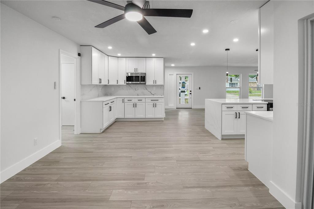 11492 93rd Street Largo, FL 33773 - Photo 15 of 37 a large kitchen with cabinets and wooden floor