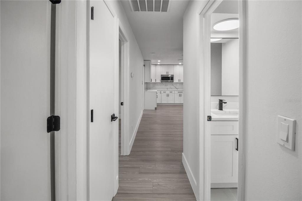 11492 93rd Street Largo, FL 33773 - Photo 21 of 37 a view of a hallway with wooden floor and staircase