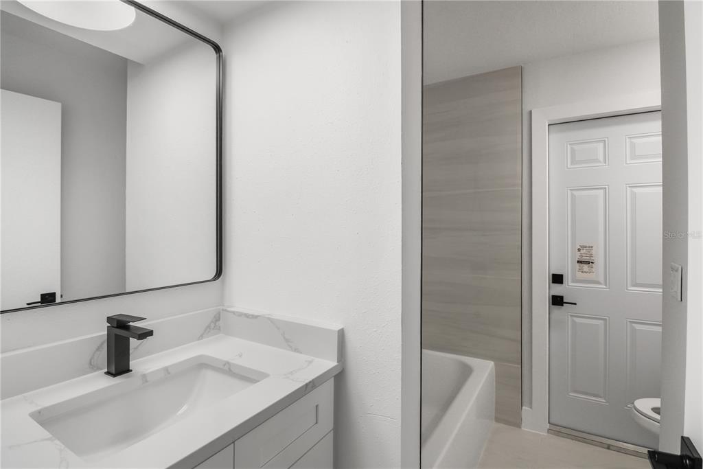 11492 93rd Street Largo, FL 33773 - Photo 22 of 37 a bathroom with a sink and a tub