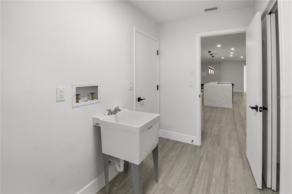 11492 93rd Street Largo, FL 33773 - Photo 36 of 37 a view of a hallway with wooden floor and a sink