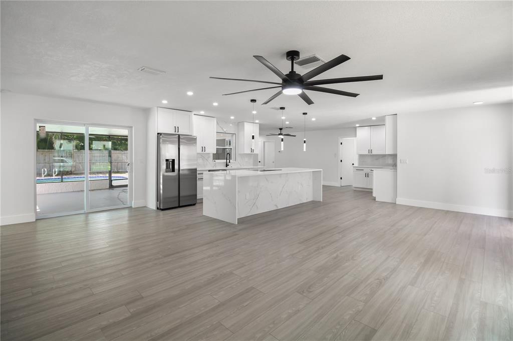 11492 93rd Street Largo, FL 33773 - Photo 6 of 37 a view of a big room with wooden floor and windows