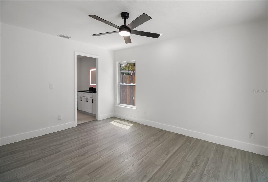 11492 93rd Street Largo, FL 33773 - Photo 8 of 37 wooden floor in an empty room with a window