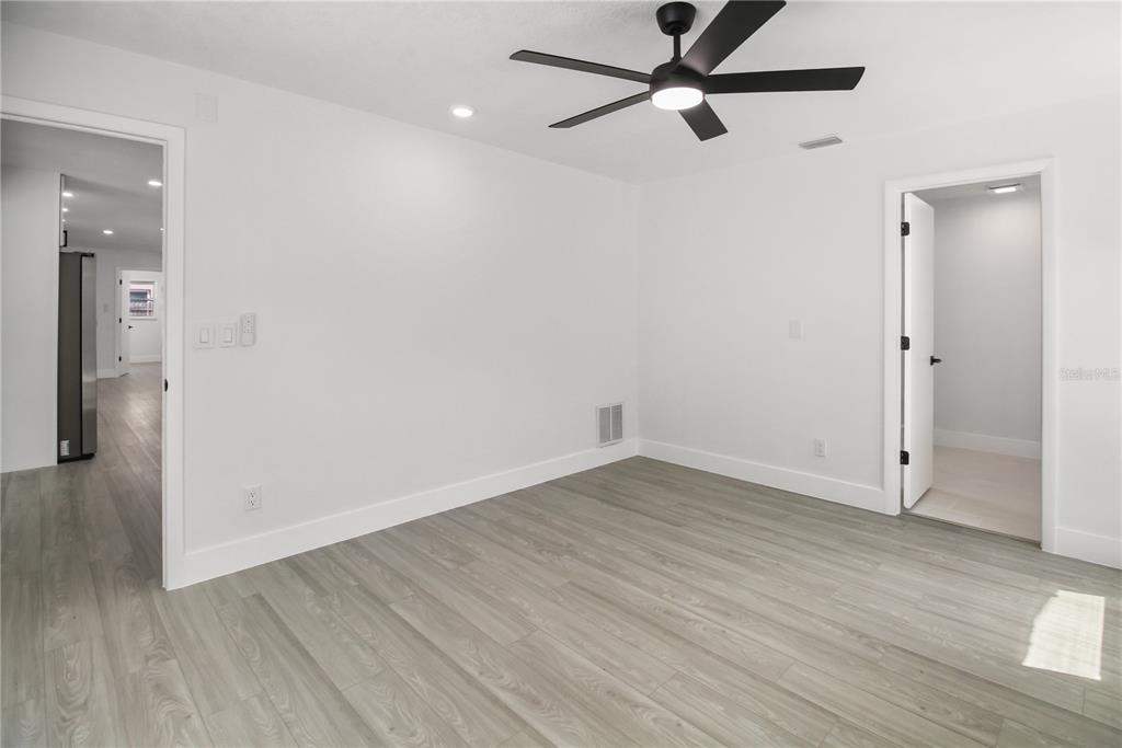11492 93rd Street Largo, FL 33773 - Photo 9 of 37 wooden floor in an empty room with a window