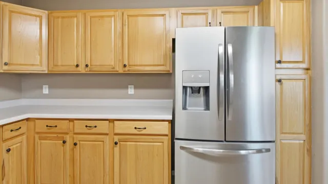 a kitchen with stainless steel appliances granite countertop white cabinets and a window