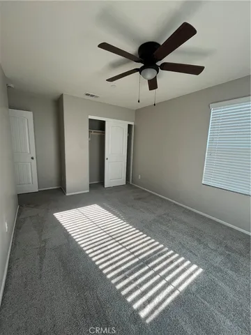 a spacious bathroom with a double vanity sink a toilet and a mirror