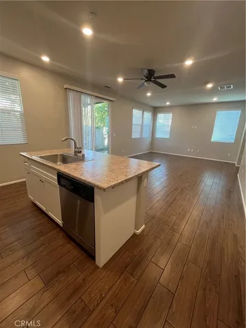 a kitchen with stainless steel appliances granite countertop a refrigerator and a stove