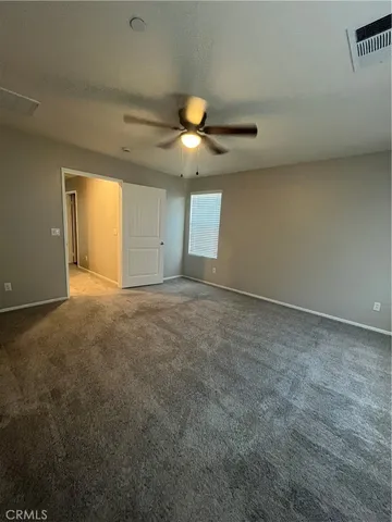 a bathroom with a granite countertop sink a toilet a mirror and shower