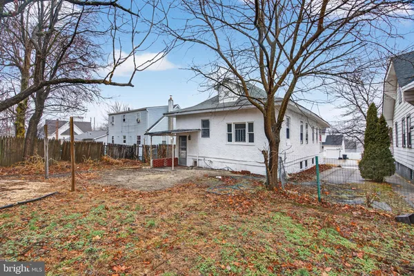 a white house that has a tree in front of it