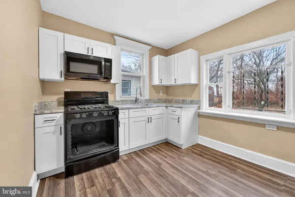 a kitchen with a stove oven and a microwave