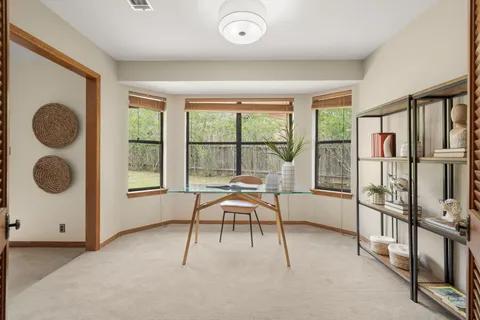 a view of a livingroom with furniture and floor to ceiling window