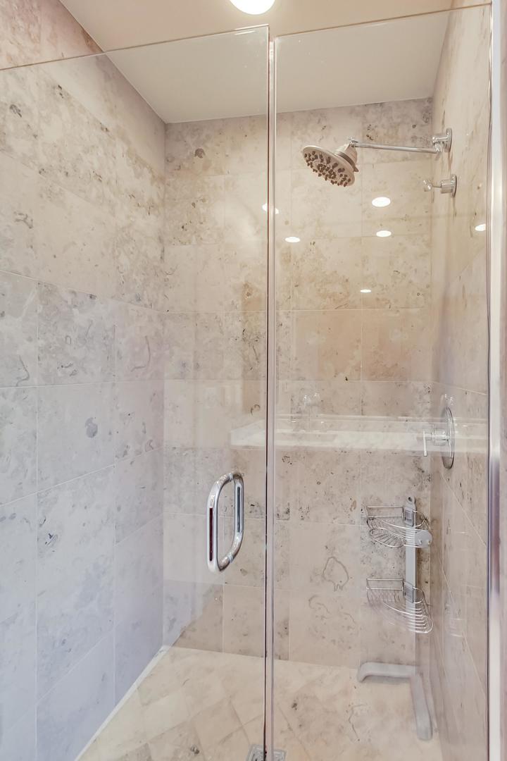 60 East Monroe Street, Unit 4404 Chicago, IL 60603 - Photo 13 of 34 a bathroom with a glass shower door