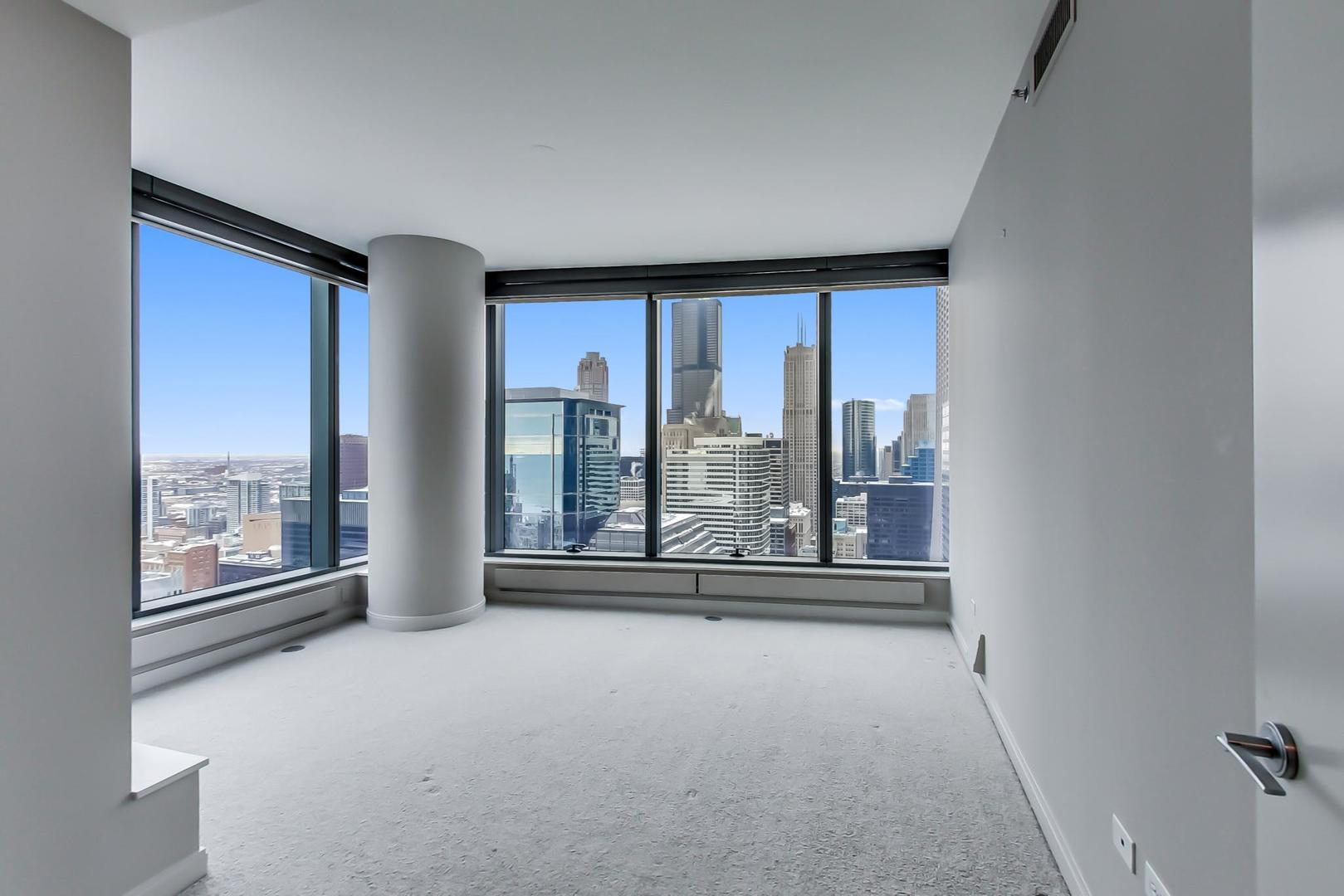 60 East Monroe Street, Unit 4404 Chicago, IL 60603 - Photo 23 of 34 an empty room with windows and city view