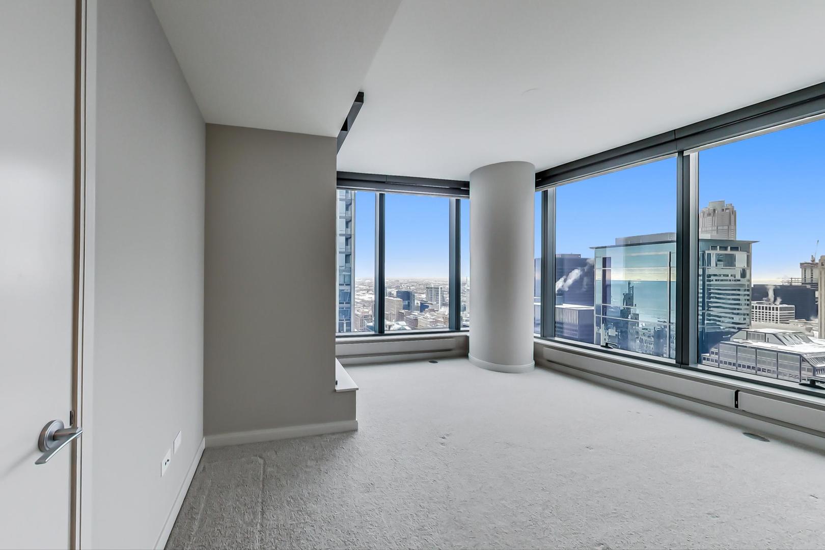 60 East Monroe Street, Unit 4404 Chicago, IL 60603 - Photo 24 of 34 a view of a big room with windows and chandelier