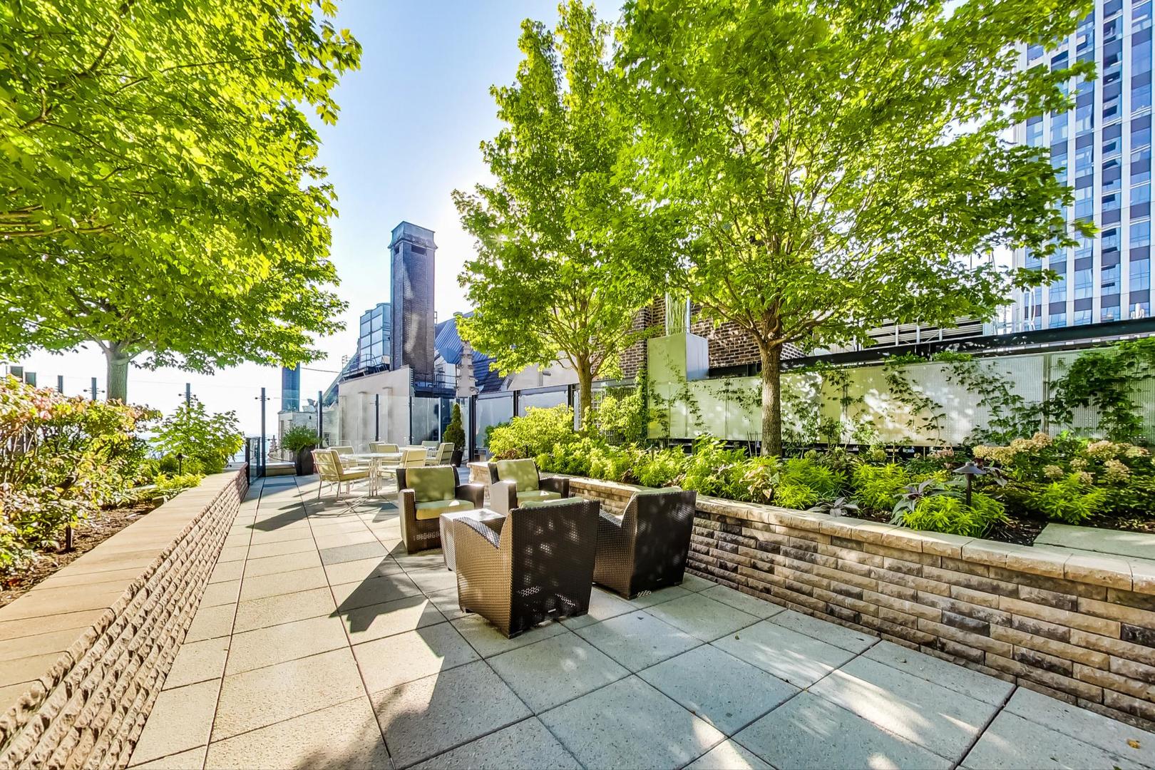 60 East Monroe Street, Unit 4404 Chicago, IL 60603 - Photo 26 of 34 a view of a patio with table and chairs and potted plants