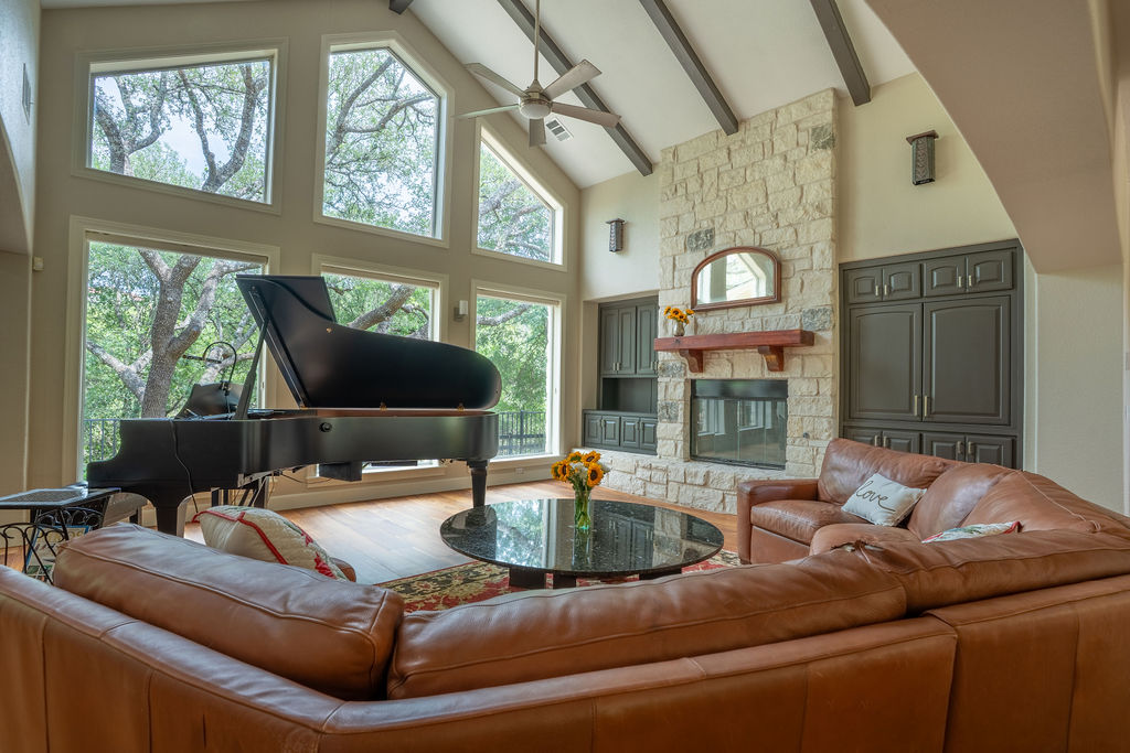 13800 Lone Rider Trail Austin, TX 78738 - Photo 5 of 27 a living room with furniture fireplace and a large window