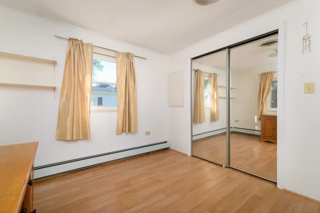 an empty room with windows and closet
