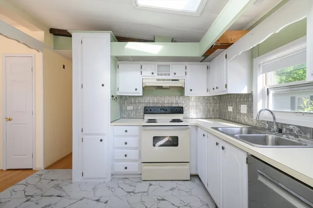 a kitchen with a sink stove and cabinets
