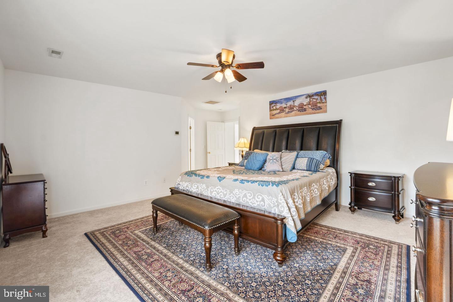 6528 Atkins Way Gainesville, VA 20155 - Photo 22 of 42 a bed sitting in a bedroom next to a lamp
