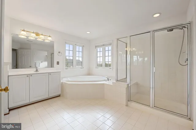 a spacious bathroom with a shower a mirror and a bathtub