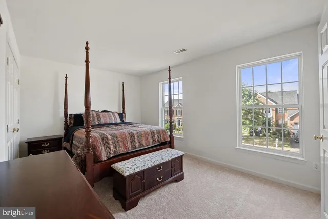 a bedroom with a bed window and couch