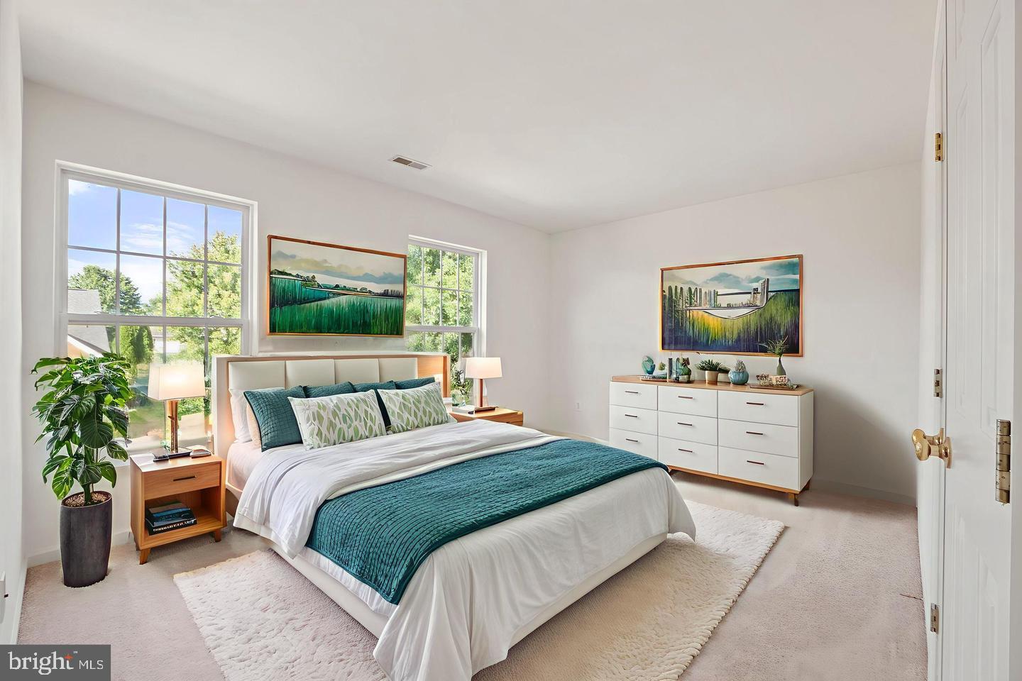 6528 Atkins Way Gainesville, VA 20155 - Photo 30 of 42 a bedroom with a large bed and a flat tv screen on dresser