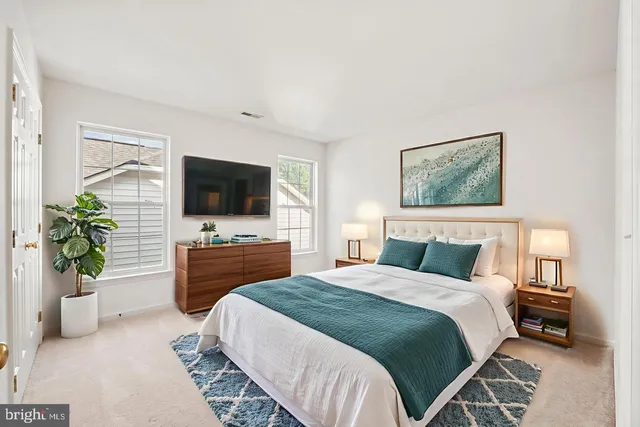 a bedroom with a bed and a television