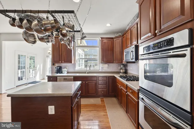 a kitchen with stainless steel appliances granite countertop a sink and stove top oven