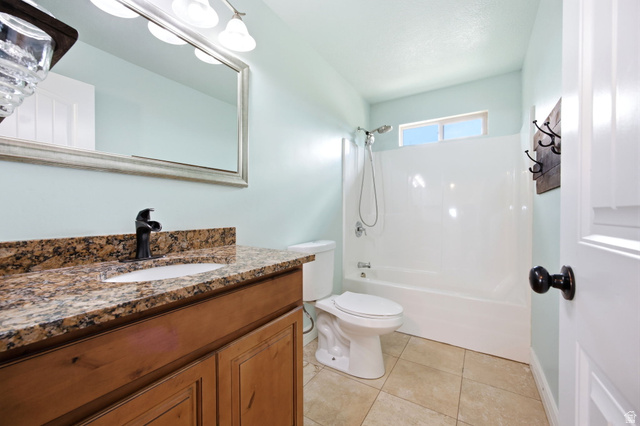 169 Taylor Road, Unit 101 Grantsville, UT 84029 - Photo 35 of 47 ADU - Bathroom featuring a wood vanity with a granite countertop, under mount sink, and black faucet