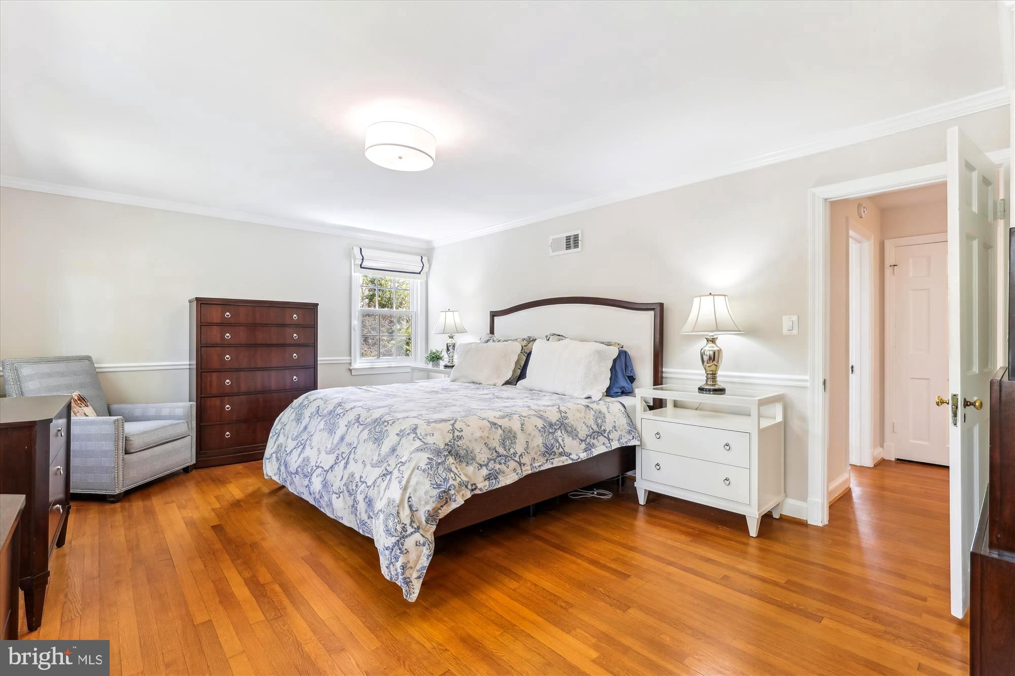 3568 Appleton Street Northwest Washington, DC 20008 - Photo 26 of 57 a bedroom with a bed and wooden floor