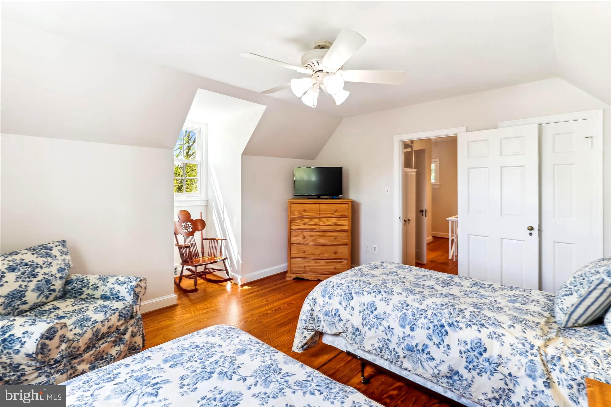 3568 Appleton Street Northwest Washington, DC 20008 - Photo 37 of 57 a bedroom with a bed dresser and a chandelier