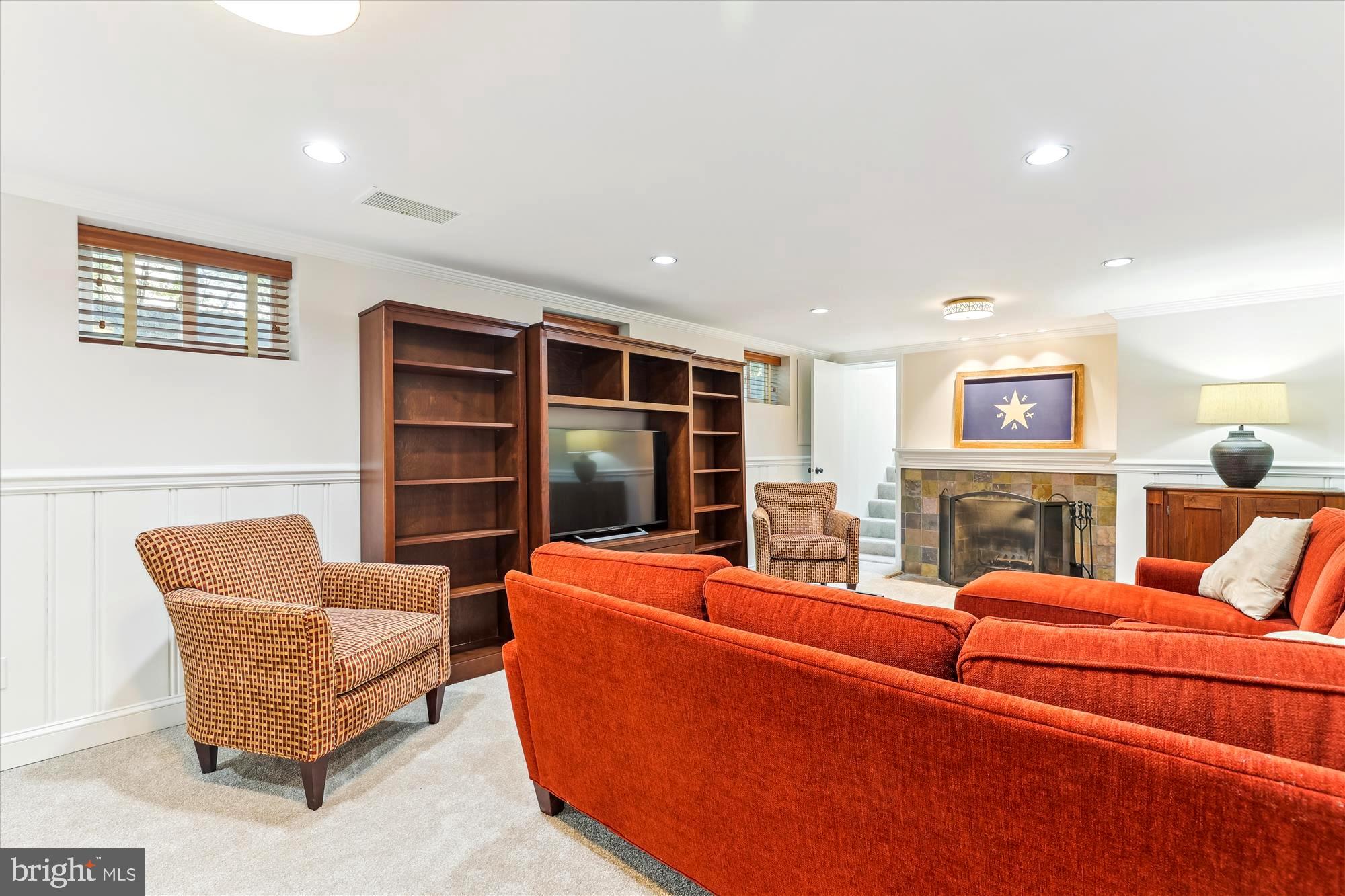 3568 Appleton Street Northwest Washington, DC 20008 - Photo 42 of 57 a living room with furniture a fireplace and a flat screen tv