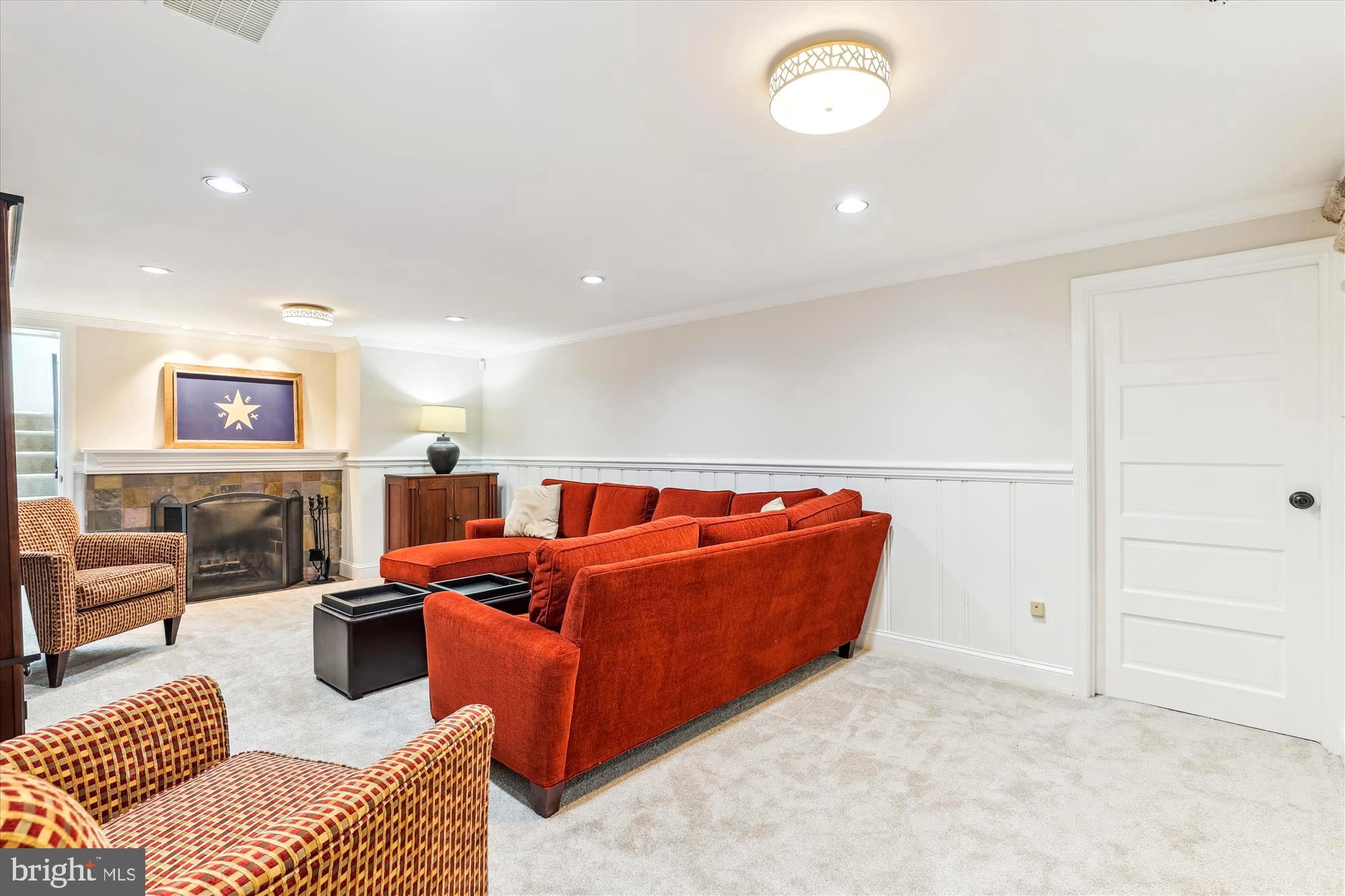 3568 Appleton Street Northwest Washington, DC 20008 - Photo 44 of 57 a living room with furniture a fireplace and a table