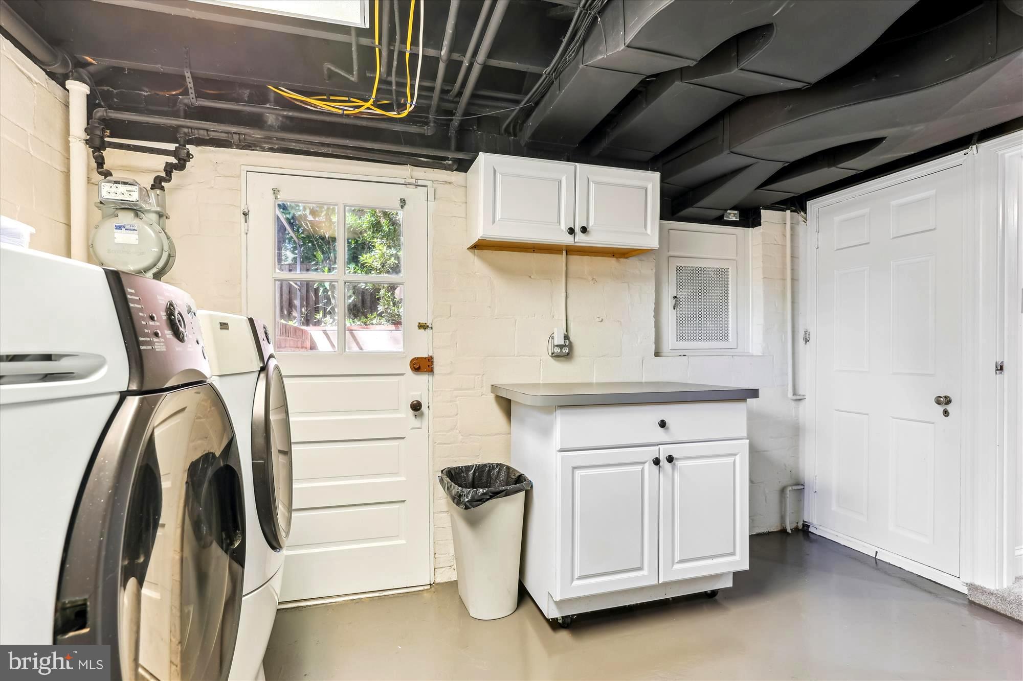 3568 Appleton Street Northwest Washington, DC 20008 - Photo 48 of 57 a kitchen with stainless steel appliances a stove a chimney and white cabinets
