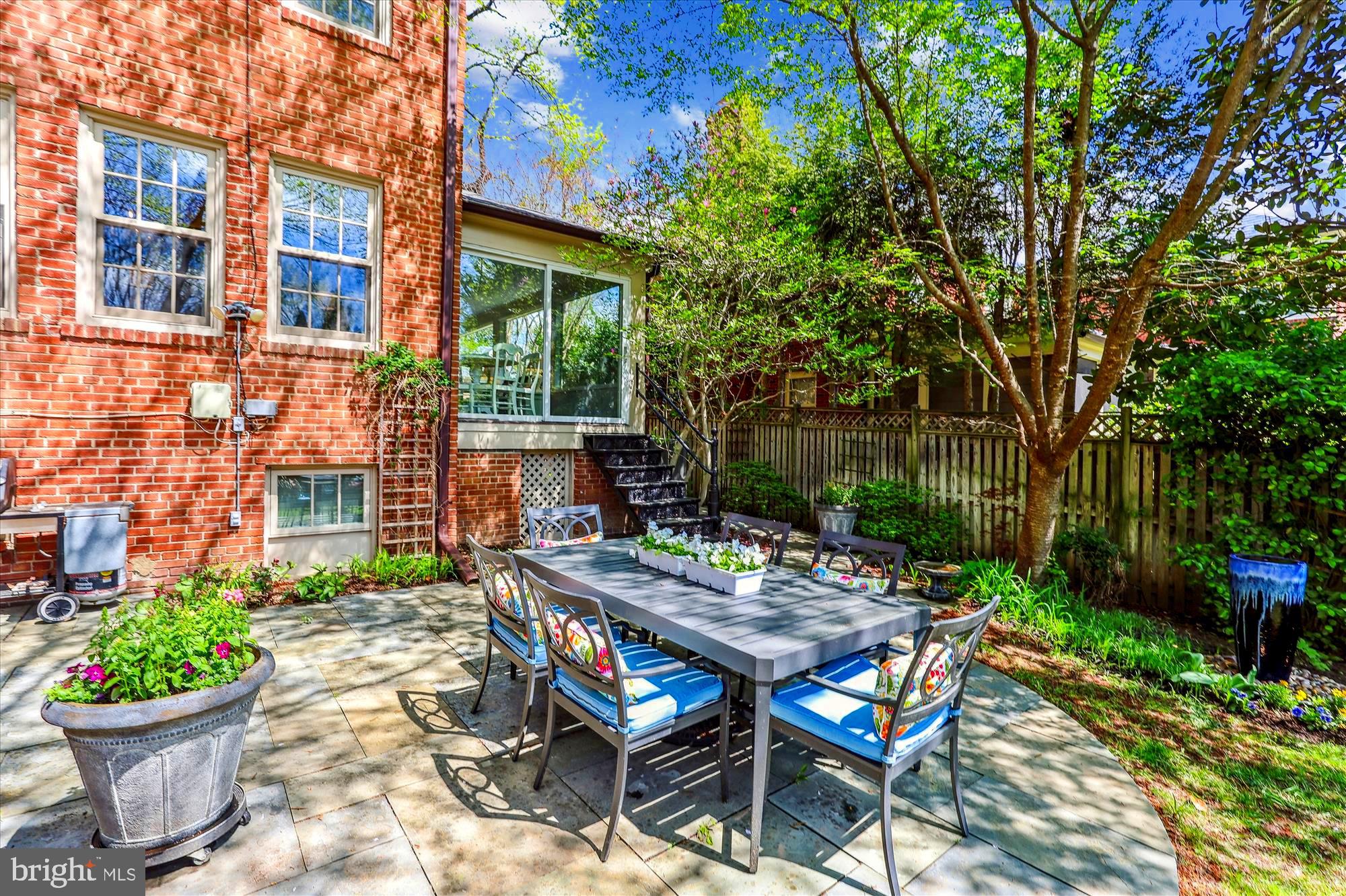 3568 Appleton Street Northwest Washington, DC 20008 - Photo 50 of 57 a view of a patio with a table and chairs potted plants and large tree