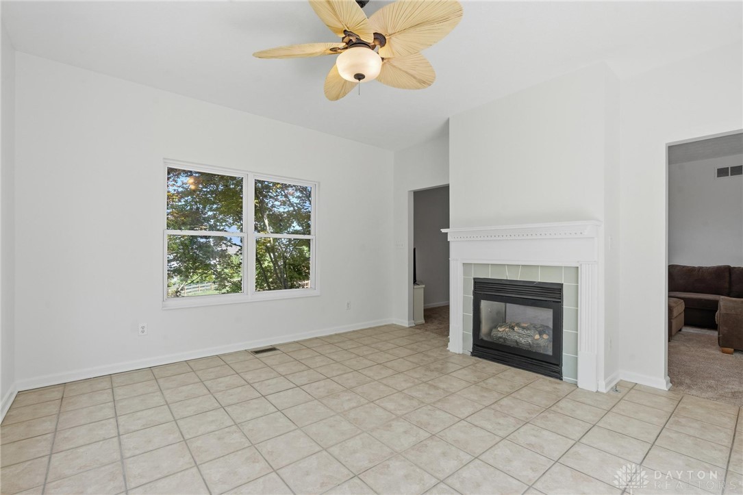 70 Martin Lane Springboro, OH 45066 - Photo 22 of 69 Bright and airy living area featuring a fireplace and large window, perfect for comfortable gatherings.