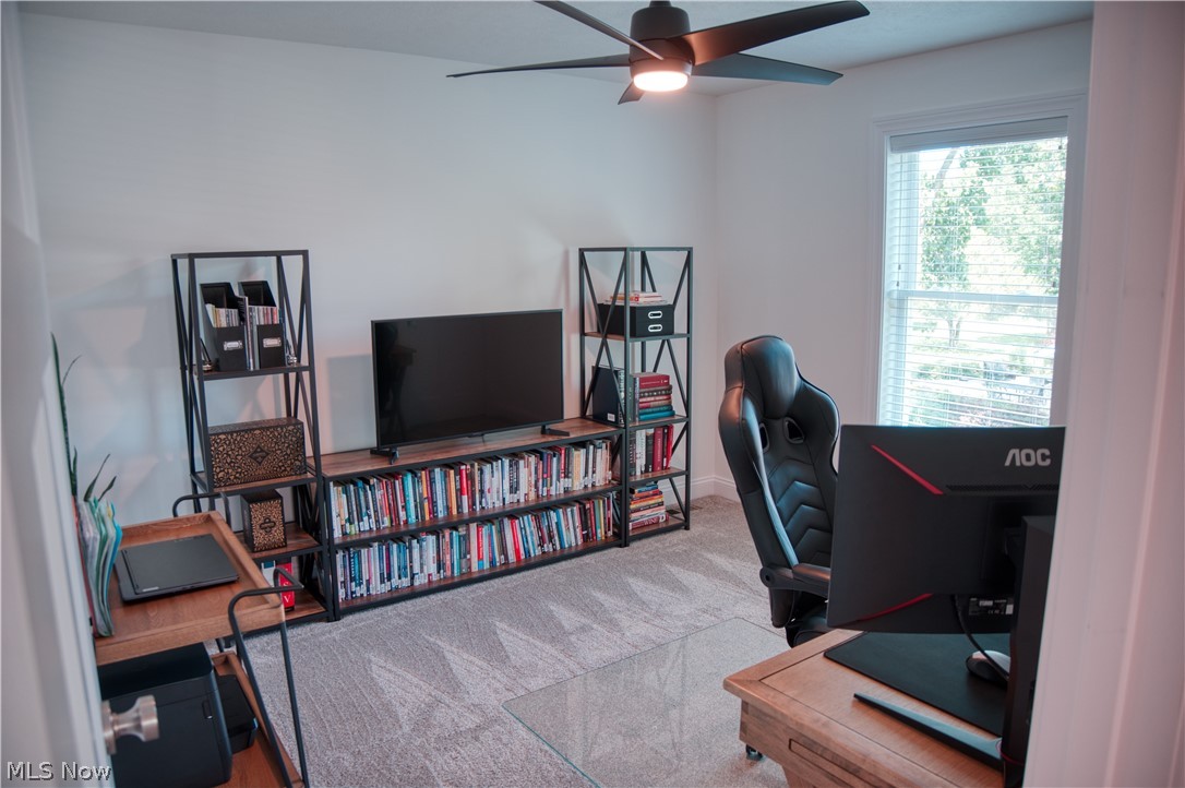 4553 Sharon Copley Road Medina, OH 44256 - Photo 14 of 32 Spacious room featuring light gray carpeting, a large window with blinds, and a ceiling fan with integrated lighting