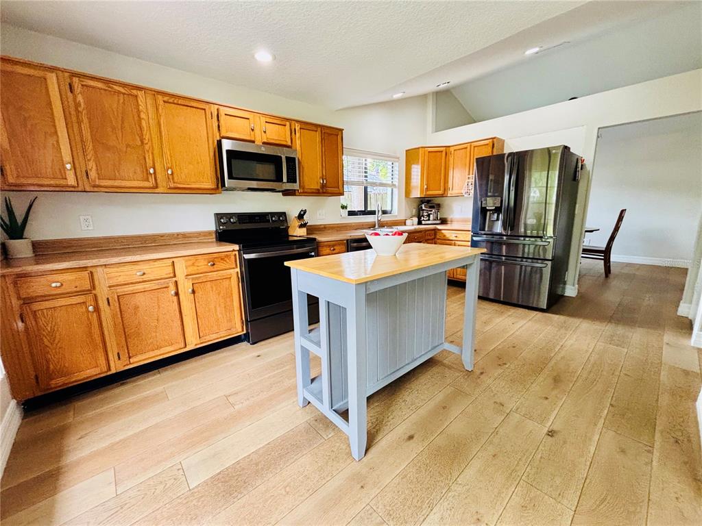 1045 Shaffer Trail Oviedo, FL 32765 - Photo 8 of 30 a kitchen with stainless steel appliances granite countertop a stove top oven a refrigerator a sink and dishwasher