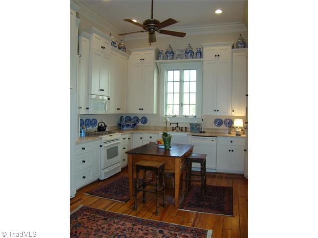 4778 Little Fox Road Randleman, NC 27317 - Photo 4 of 16 Kitchen. Marble Countertops, Paneled Refrigerator, Gas Range Top with Electric Oven, Farmhouse Sink, Microwave, Dishwasher, Hardwood Floors