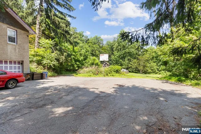 a view of a house with a yard and garage