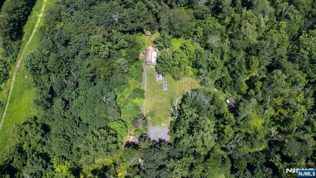 77 Voorhis Road Lincoln Park, NJ 07035 - Photo 5 of 21 an aerial view of residential house with outdoor space and trees all around