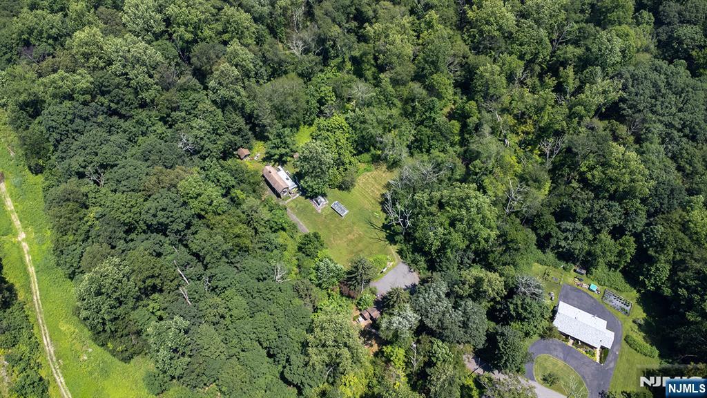 77 Voorhis Road Lincoln Park, NJ 07035 - Photo 7 of 21 an aerial view of residential house with outdoor space and trees all around