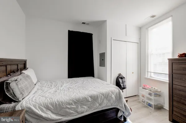 a bedroom with a bed and a window