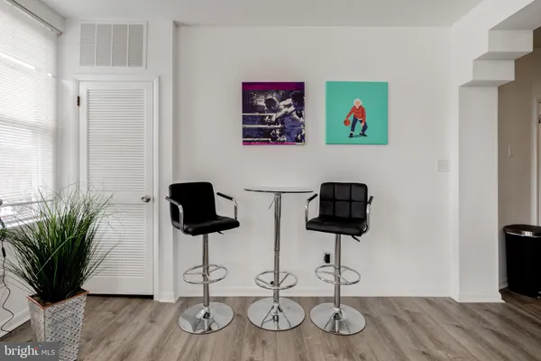 a view of a workspace with furniture and wooden floor
