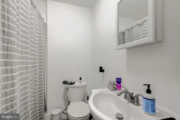 a white toilet sitting next to a bathroom sink