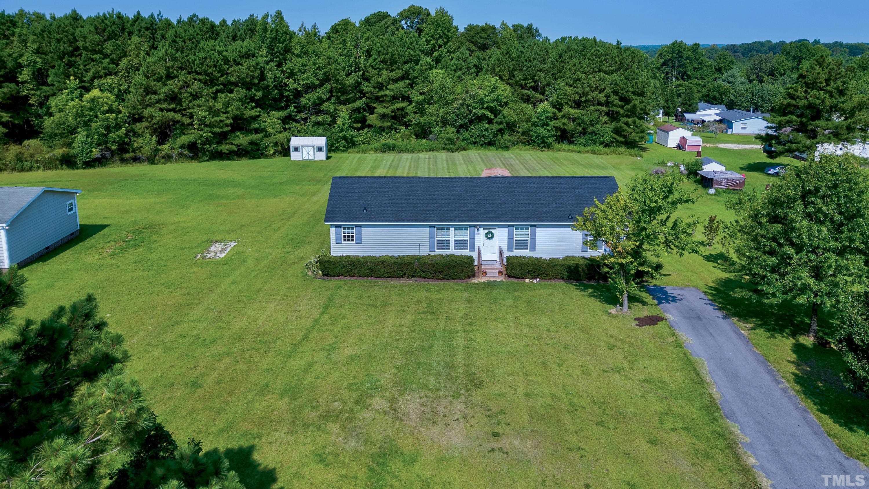 8308 South Creek Road Willow Spring, NC 27592 - Photo 1 of 42 an aerial view of a house