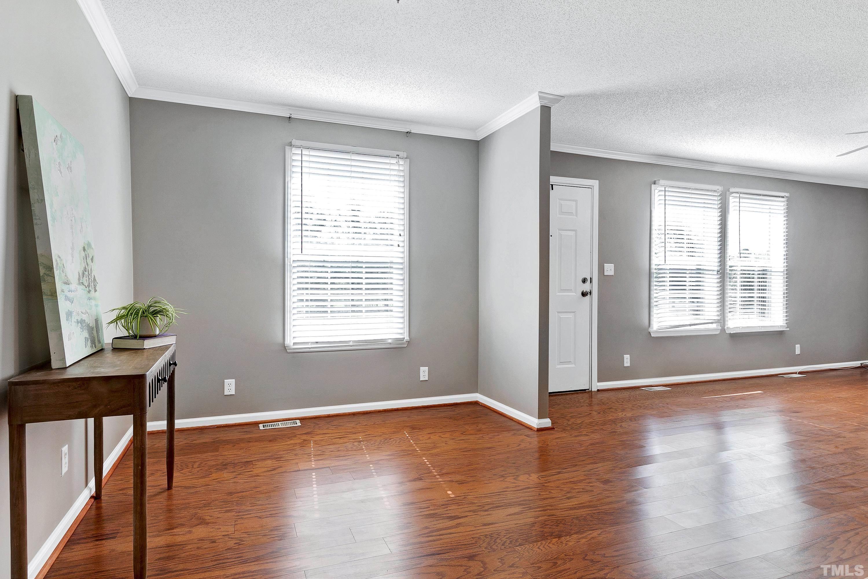 8308 South Creek Road Willow Spring, NC 27592 - Photo 18 of 42 an empty room with wooden floor and windows