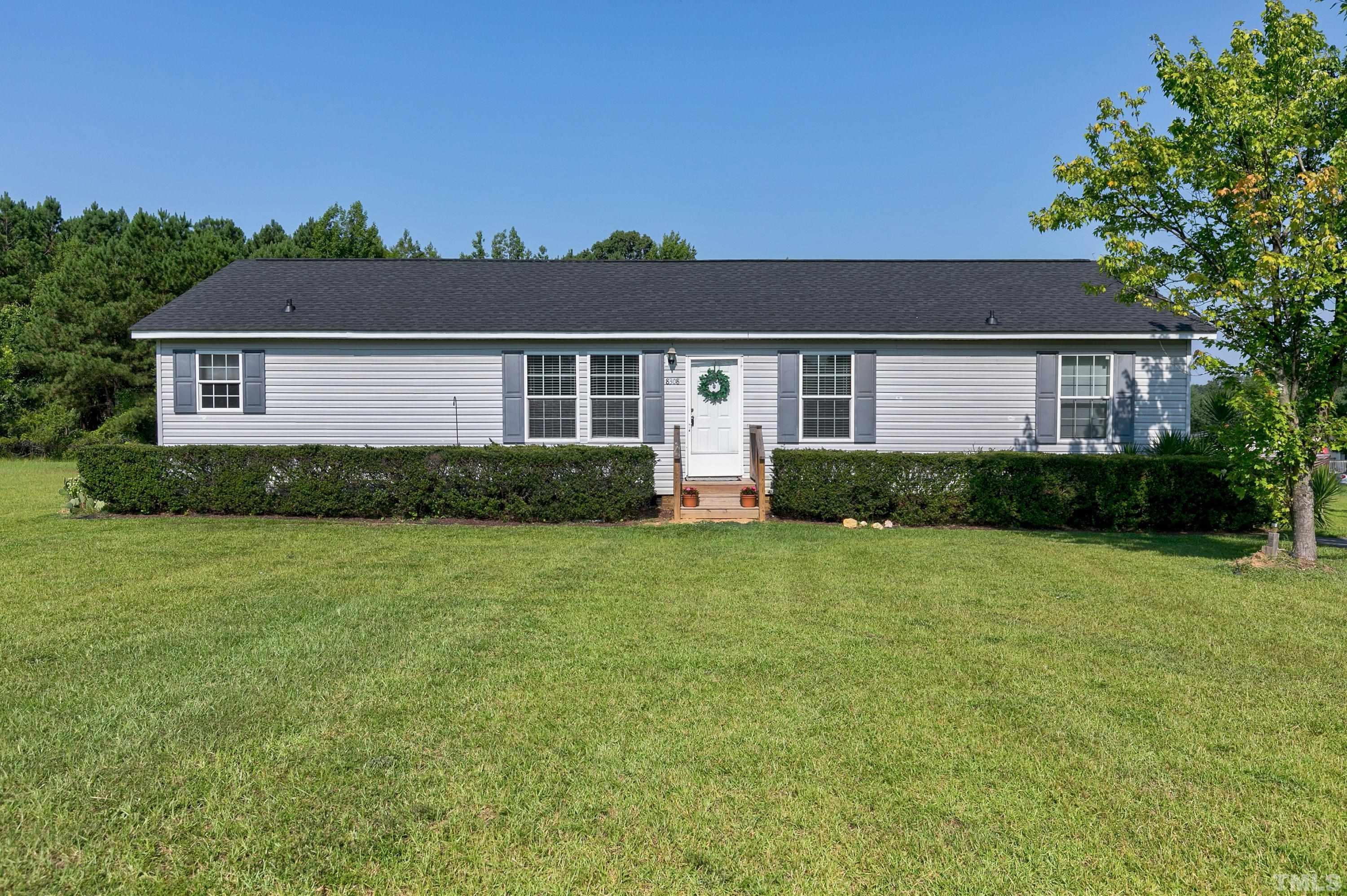 8308 South Creek Road Willow Spring, NC 27592 - Photo 2 of 42 front view of a house with a yard
