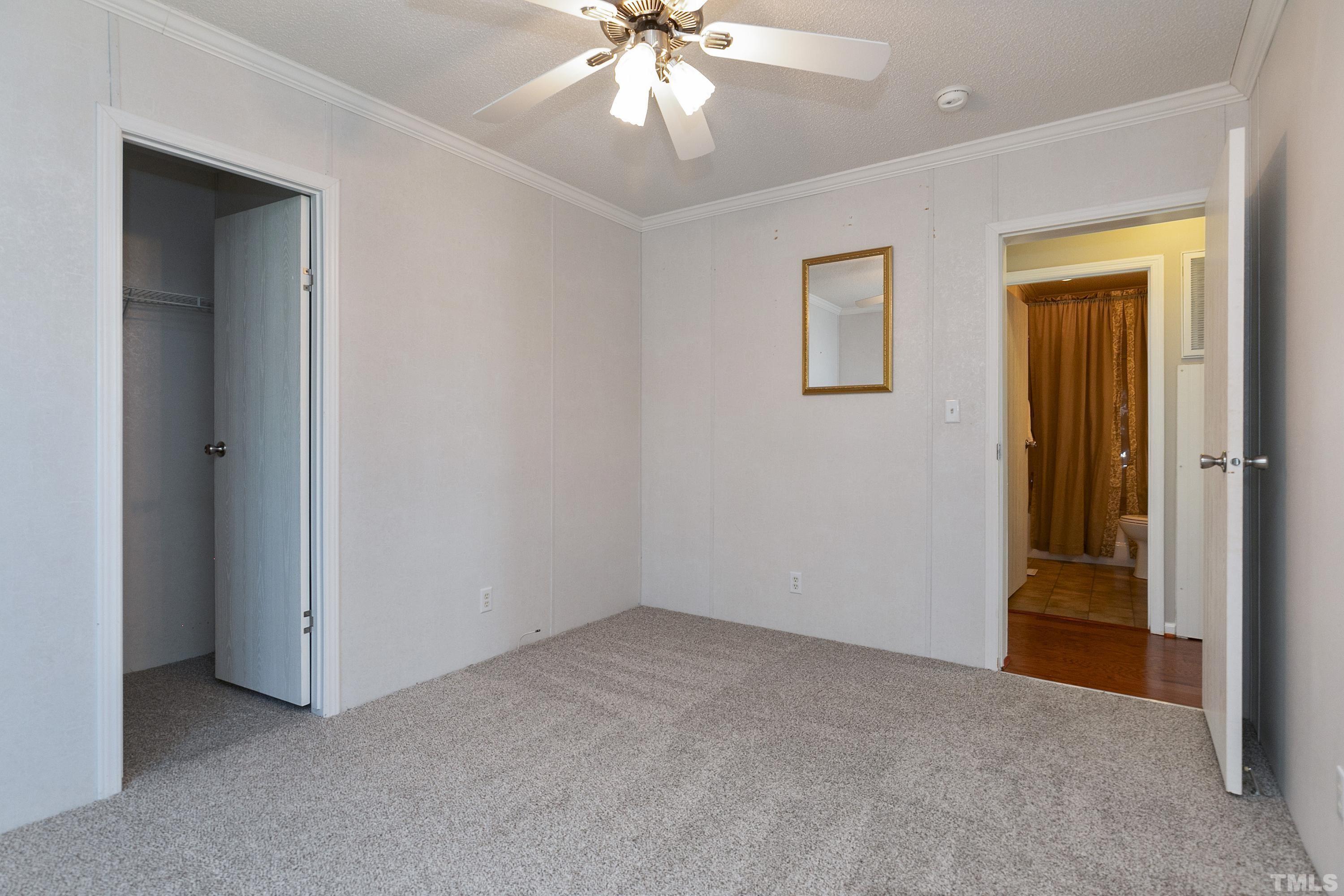 8308 South Creek Road Willow Spring, NC 27592 - Photo 27 of 42 an empty room with windows and fan