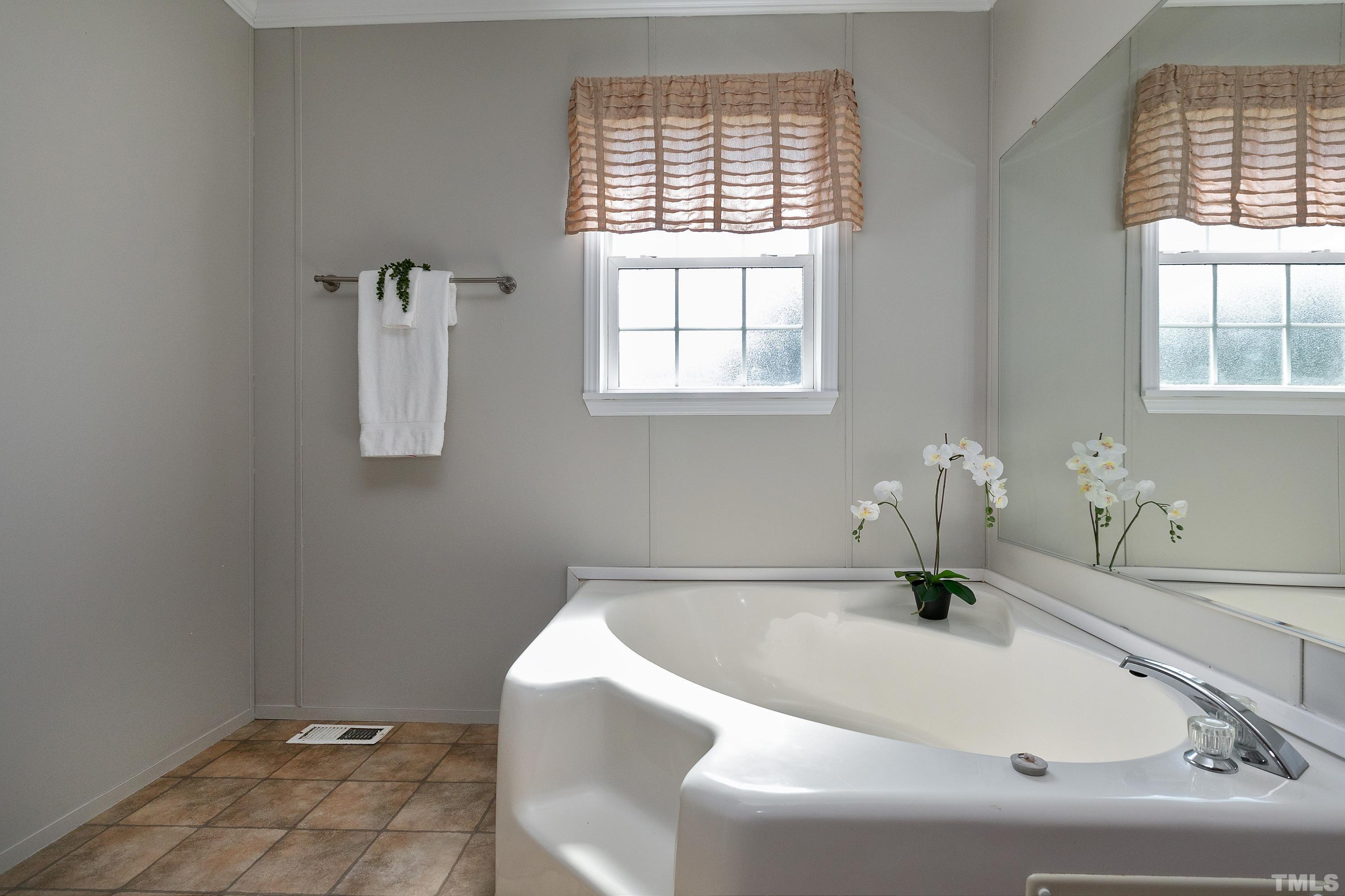 8308 South Creek Road Willow Spring, NC 27592 - Photo 33 of 42 a bathroom with a sink and a window
