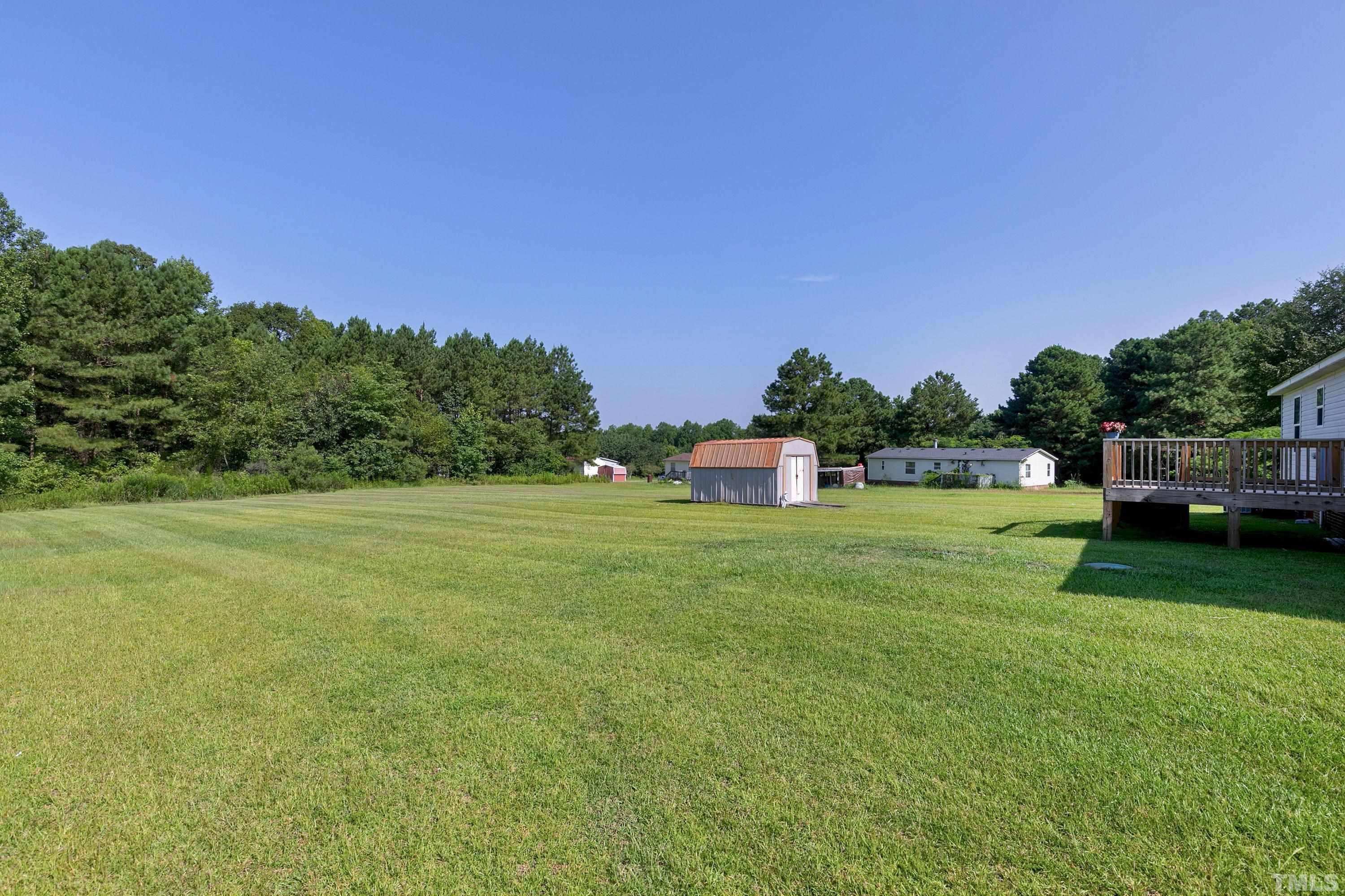 8308 South Creek Road Willow Spring, NC 27592 - Photo 5 of 42 a view of a house with a big yard